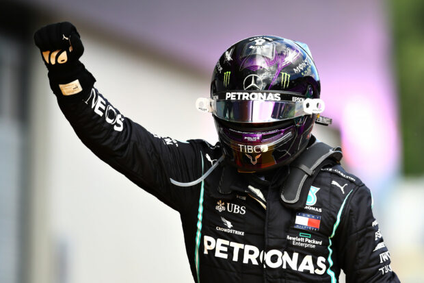 Lewis Hamilton celebrates with a raised fist during a race, 2K Desktop Wallpaper