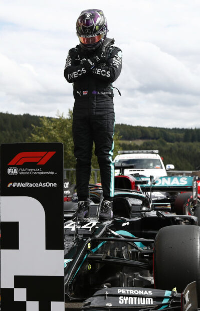 Lewis Hamilton celebrating on top of his Formula 1 car after winning a race, 2K Mobile Wallpaper