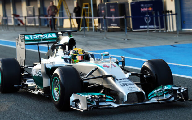 Lewis Hamilton is driving a Petronas Formula 1 car during a race session, 2K Desktop Wallpaper