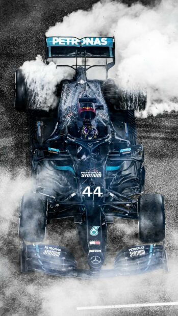 Lewis Hamilton wallpapers showing a Formula 1 car performing a burnout with smoke, HD Mobile Wallpaper