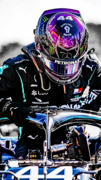 Lewis Hamilton wearing a reflective racing helmet preparing in the car, HD Phone Wallpaper