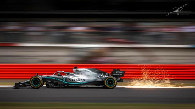 Lewis Hamilton racing his Formula 1 car at high speed with sparks flying, HD Desktop Wallpaper