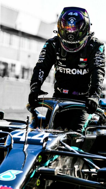 Lewis Hamilton in his racing suit standing by his Formula 1 car, HD Phone Wallpaper