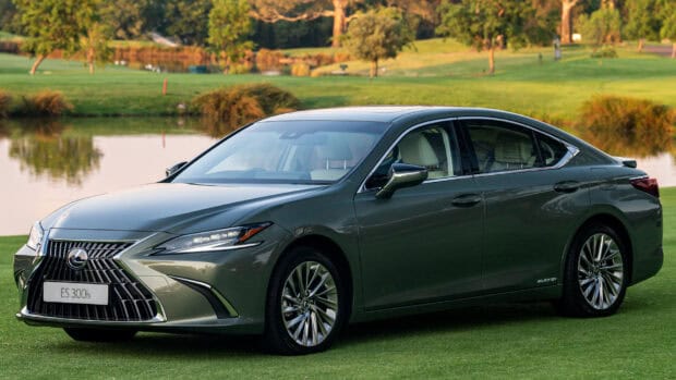 Lexus Es 300h is parked on a grassy field near a lake in a serene environment, HD Desktop Wallpaper
