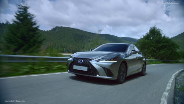 A Lexus Es is driving on a winding road surrounded by green trees and hills, 4K Desktop Wallpaper