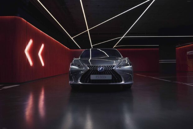 A Lexus Es 300h car is parked in a futuristic garage with neon lights and red walls, 2K Desktop Wallpaper