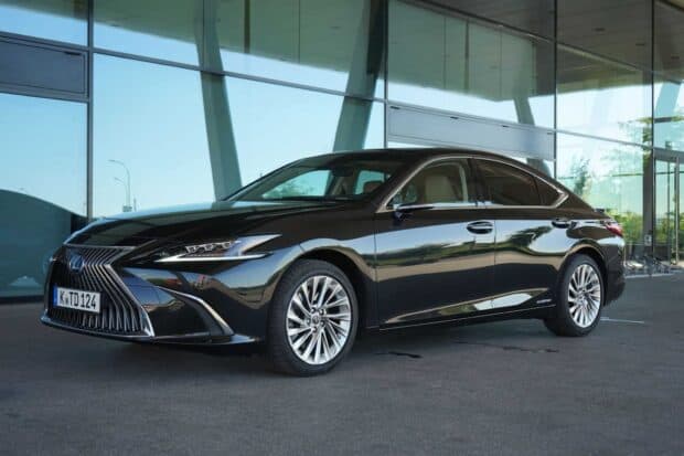 A black Lexus Es sedan parked in front of a modern glass building, HD Desktop Wallpaper