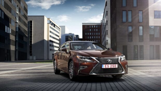 A Lexus Es luxury sedan is parked in a modern urban area with high rise buildings, 4K Desktop Wallpaper