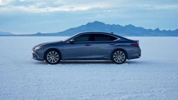 A Lexus Es is parked on a snowy plain with distant mountains under a cloudy sky, HD Desktop Wallpaper