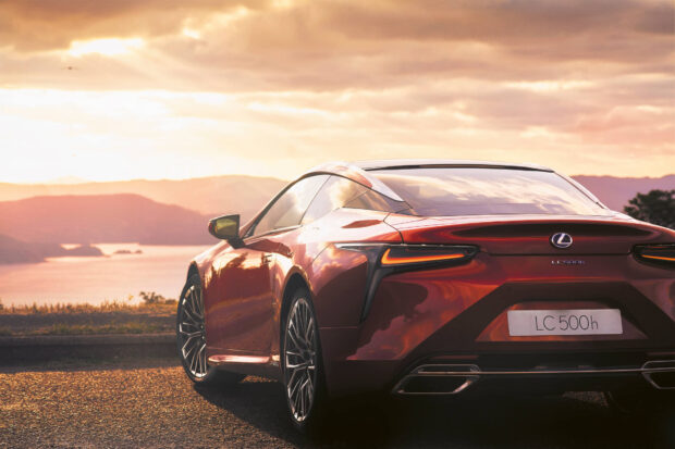 A red Lexus LC 500h is parked with a scenic sunset over the mountains in the background, HD Desktop Wallpaper