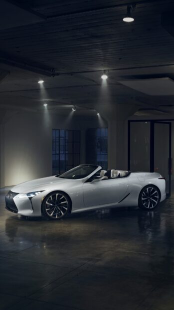 A white Lexus LC convertible is parked inside a sleek urban garage at night, 2K Mobile Wallpaper