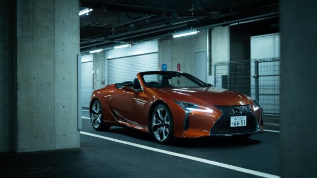 A Lexus LC convertible is parked inside a modern underground garage with concrete pillars, 4K Desktop Wallpaper