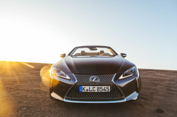 A black Lexus LC convertible car with the sun shining on a desert road, 2K Desktop Wallpaper