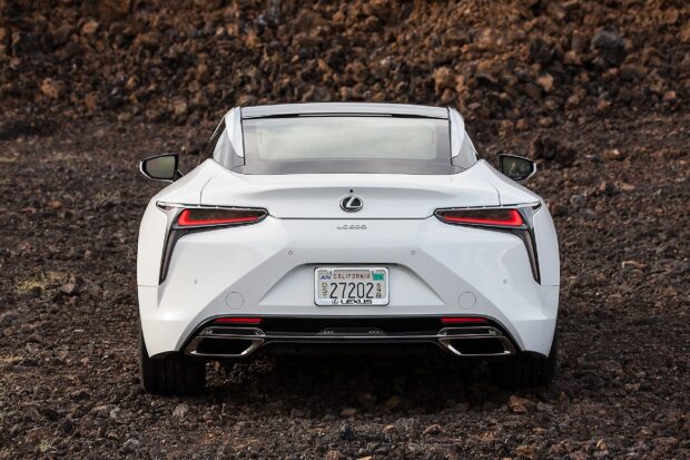 A white Lexus LC is shown from the rear on rocky terrain, 2K Desktop Wallpaper