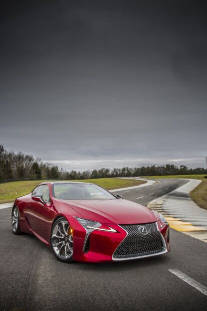 A red Lexus LC sports car is parked on a curved race track under a cloudy sky, HD Mobile Wallpaper
