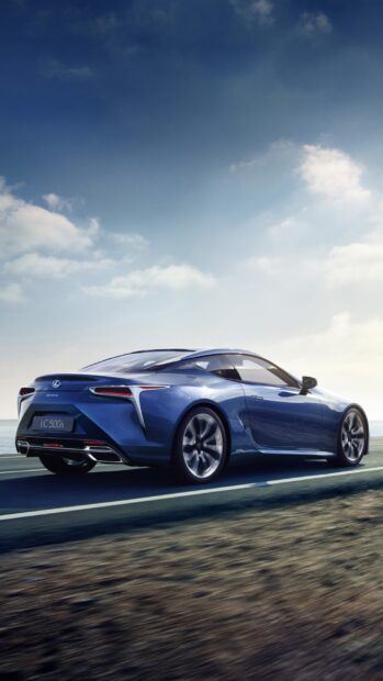 A blue Lexus LC is driving on a coastal road under a clear sky, HD Phone Wallpaper