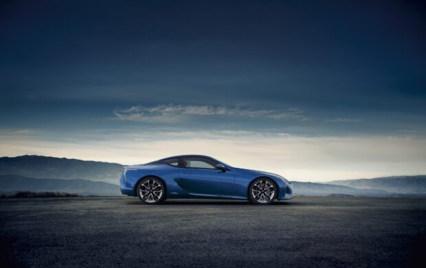 A blue Lexus LC sports car is parked with mountains and clear sky in the background, HD Desktop Wallpaper