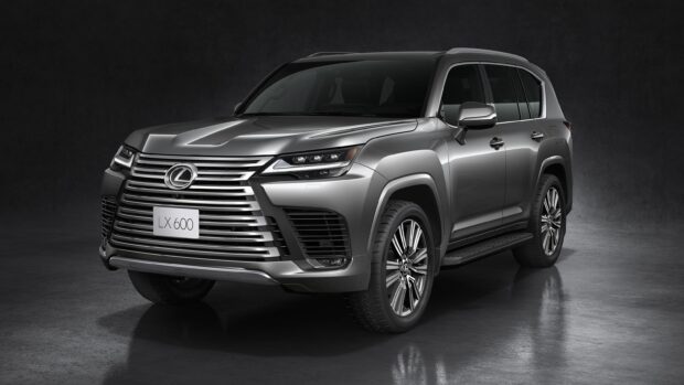 A silver Lexus LX 600 is shown from the front side in a studio setting with dark background, 2K Desktop Wallpaper