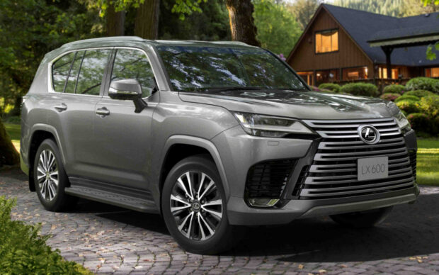 A silver Lexus LX 600 parked on a stone driveway near a wooden house surrounded by greenery, HD Desktop Wallpaper