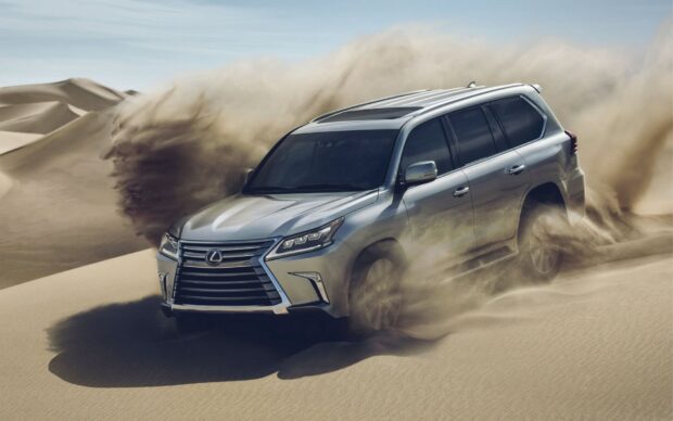 A Lexus LX is driving dynamically through sandy desert dunes, HD Desktop Wallpaper