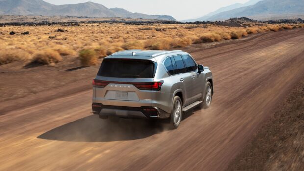 A Lexus LX SUV is driving along a dusty desert trail with mountains in the background, HD Desktop Wallpaper