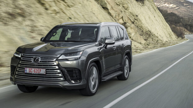 A Lexus LX is shown driving along a winding mountain road with rocky scenery, 4K Desktop Wallpaper