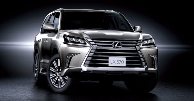 A silver Lexus LX SUV shown from the front with its grille and headlights illuminated, 4K Desktop Wallpaper
