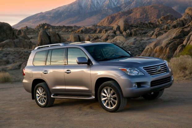 A Lexus LX parked on a desert dirt road with rocky mountains in the background, 2K Desktop Wallpaper
