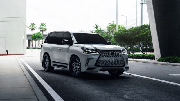A white Lexus LX is parked under a concrete structure near palm trees, 4K Desktop Wallpaper