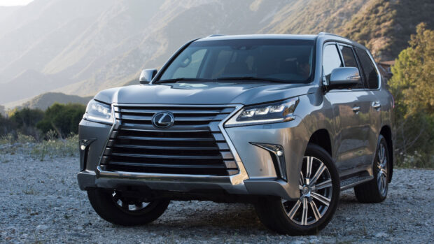 A silver Lexus LX SUV parked on a rocky terrain with mountains in the background, 4K Desktop Wallpaper