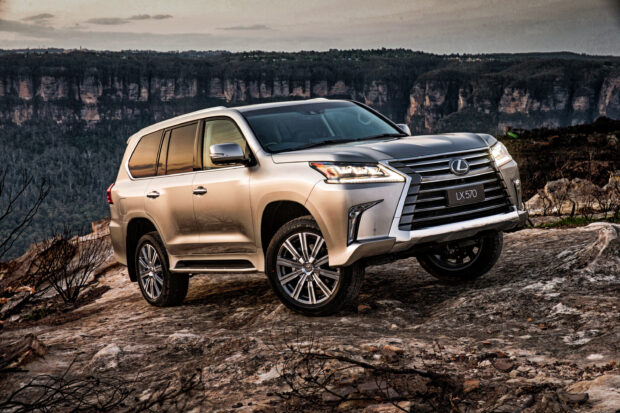 A Lexus LX 570 parked on rocky terrain with a mountain backdrop, 2K Desktop Wallpaper