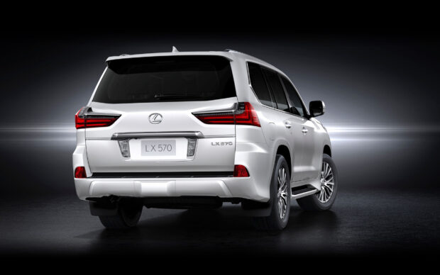 A white Lexus LX is shown from the rear in a studio setting with a dark background, 2K Desktop Wallpaper