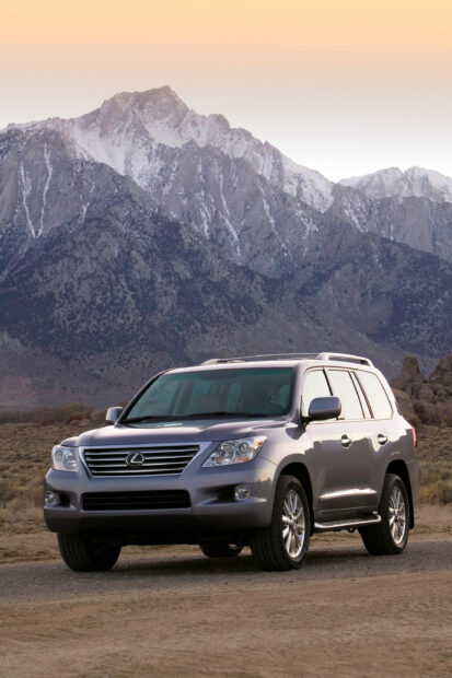 A Lexus Lx is parked on a dirt road with snowy mountains in the background, 2K Mobile Wallpaper