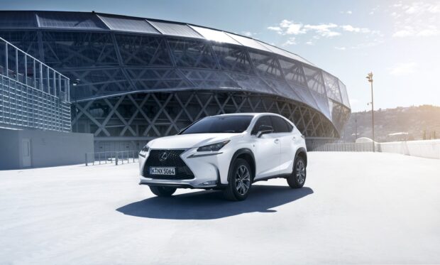 A white Lexus NX stands in front of a modern architectural building on a sunny day, 2K Desktop Wallpaper