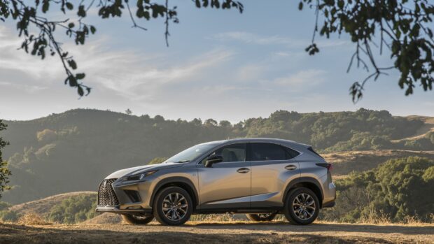 A Lexus Nx Wallpapers HD is parked on a dirt road with hills and trees in the background, 2K Desktop Wallpaper
