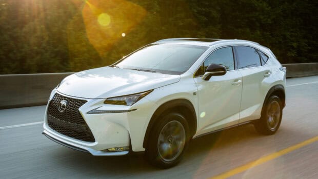 A white Lexus Nx is driving on a road surrounded by trees with sunlight creating lens flares, 4K Desktop Wallpaper