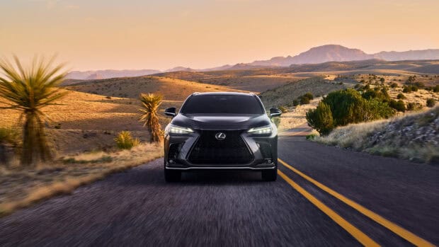 A Lexus Nx is driving along a scenic desert road with hills and trees in the background, 4K Desktop Wallpaper