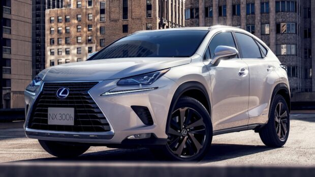 A silver Lexus Nx is parked in a city rooftop area against tall buildings, HD Desktop Wallpaper