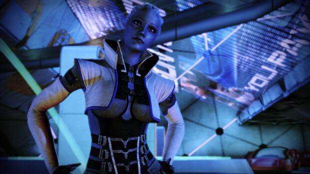 Liara Tsoni stands confidently in a high tech environment with blue lighting, 2K Desktop Wallpaper