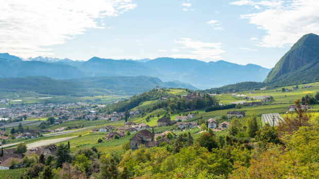 A scenic view of Liechtenstein with mountains and green fields under a partly cloudy sky, 4K Desktop Wallpaper
