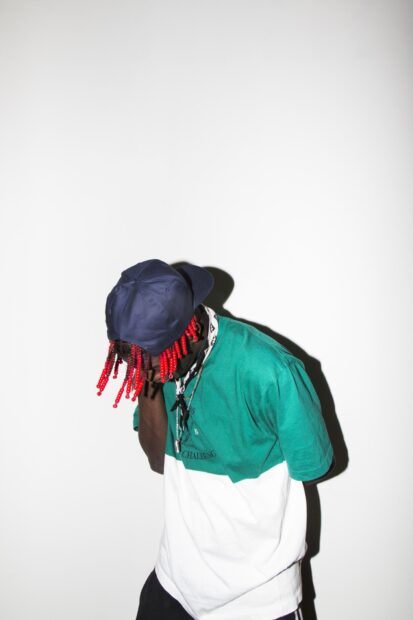 Lil Yachty is wearing a green and white shirt with a navy cap and red braided hair, HD Phone Wallpaper