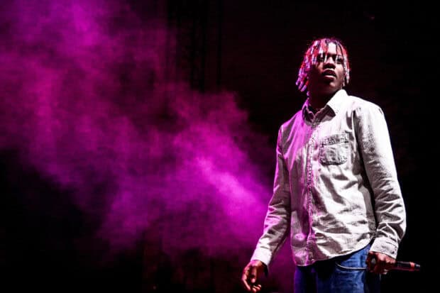 Lil Yachty stands on stage with purple smoke surrounding him during a performance, 2K Desktop Wallpaper