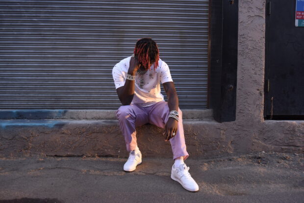 Lil Yachty sitting on a ledge wearing pink pants and white shoes, HD Desktop Wallpaper