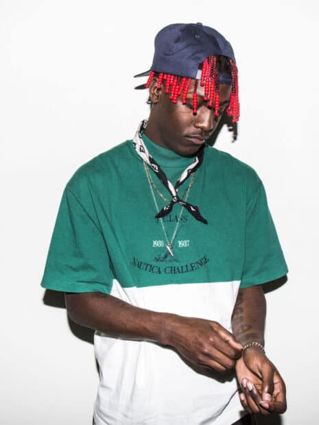 Lil Yachty adjusts his bracelet while wearing a green and white shirt and a cap, HD Desktop Wallpaper