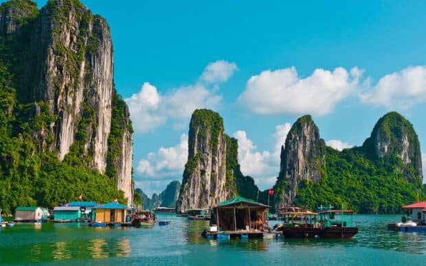 Vietnam Wallpapers capture the scenic limestone karsts and floating houses on calm blue waters in Vietnam, 2K Desktop Wallpaper