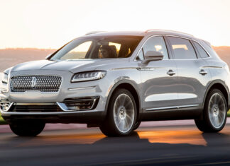 A silver Lincoln Nautilus drives along a road by the water at sunset, HD Desktop Wallpaper