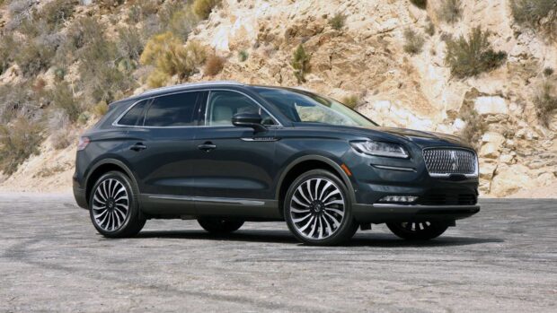 A black Lincoln Nautilus SUV parked near rocky hills under a clear sky, HD Desktop Wallpaper