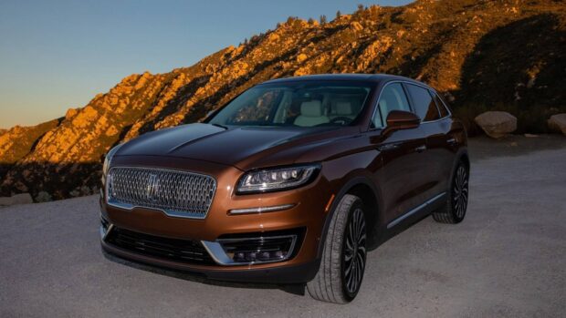 A brown Lincoln Nautilus parked near rocky mountains at sunset, HD Desktop Wallpaper