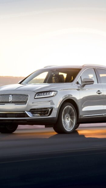 A luxury Lincoln Nautilus driving on the road at sunset, 4K Phone Wallpaper