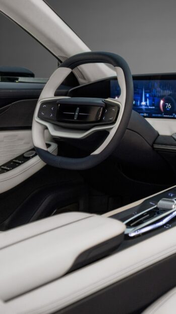 A luxurious Lincoln car interior featuring a modern steering wheel and dashboard display, 4K Phone Wallpaper